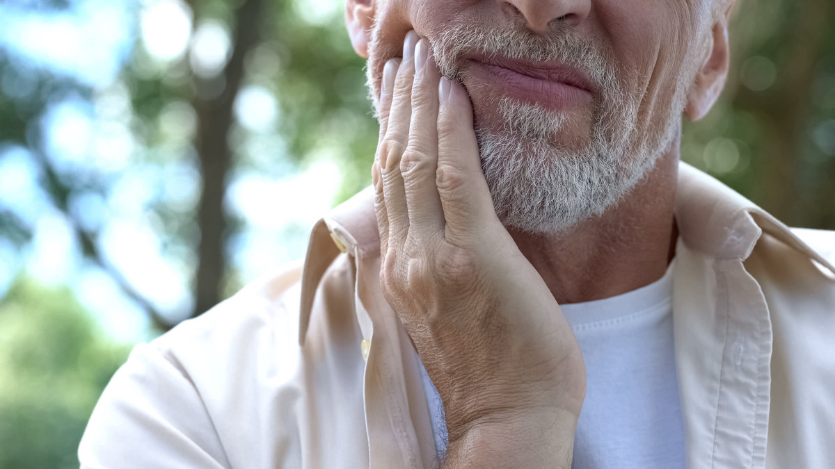 Senior man having problem with teeth, social program of dental prosthetics Senior man having problem with teeth, social program of dental prosthetics