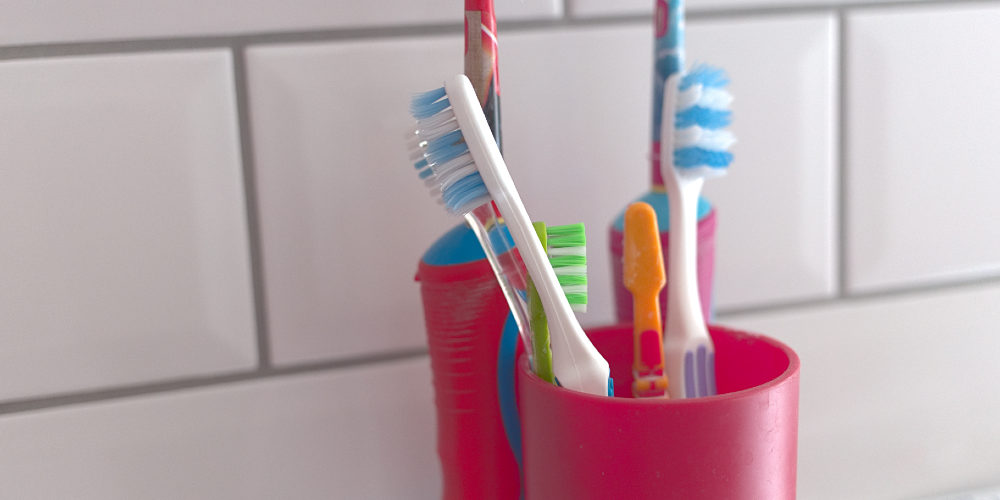 Variety of toothbrush inside a mouthwash cup
