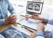 Professional Dentist showing jaw and teeth the x-ray photograph