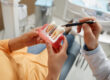 Woman holding tooth model during consultation on dental implant