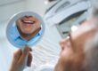 Dental patient smiling confidently after successful implant treatment supported by bone grafting
