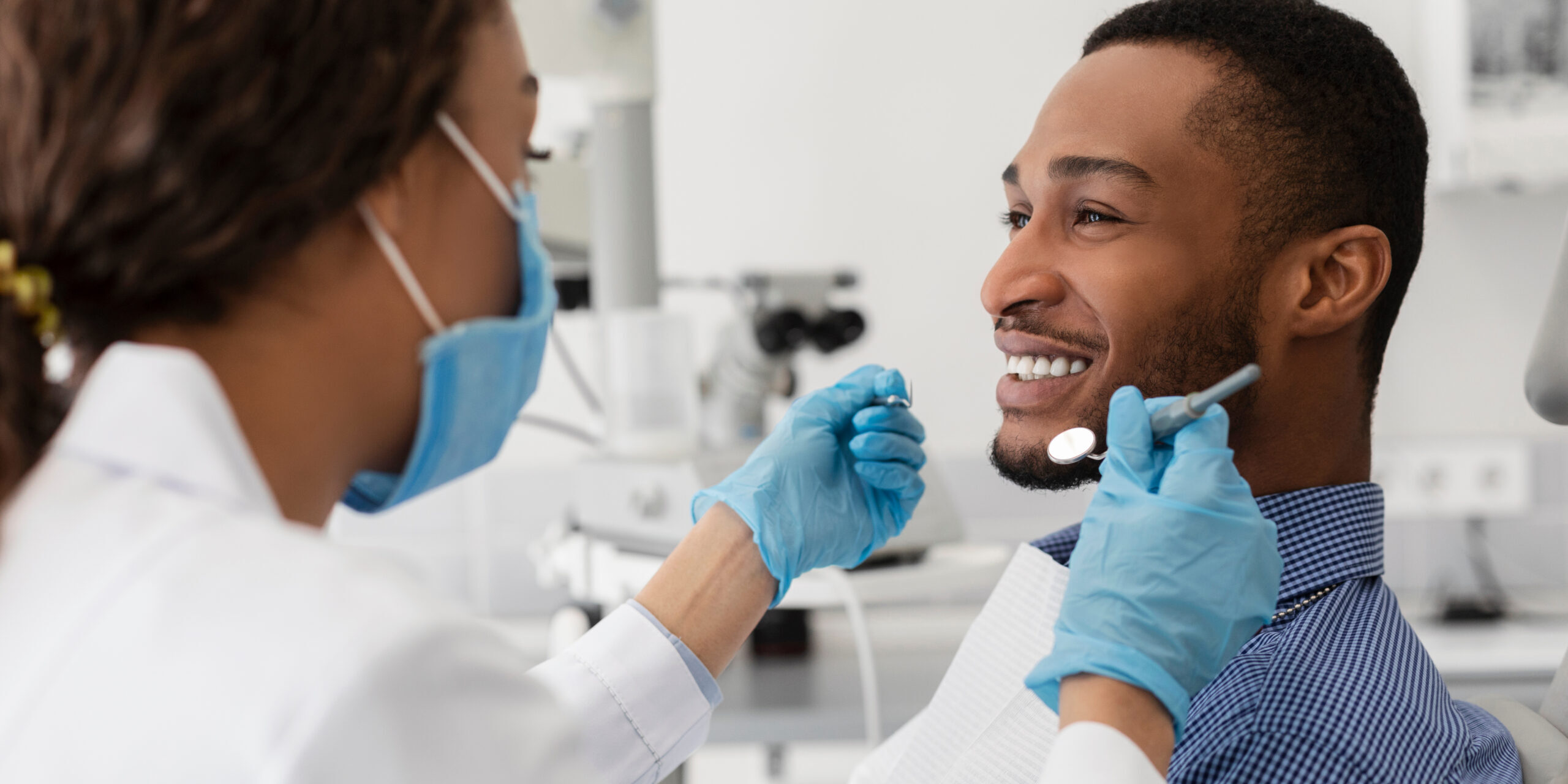 Tongue Tie Airway Consultation Adult patient smiling with dentist during a tongue tie and airway consultation