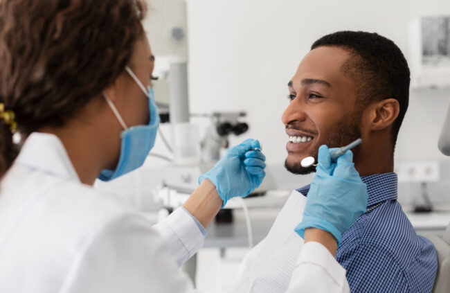 Tongue Tie Airway Consultation Adult patient smiling with dentist during a tongue tie and airway consultation