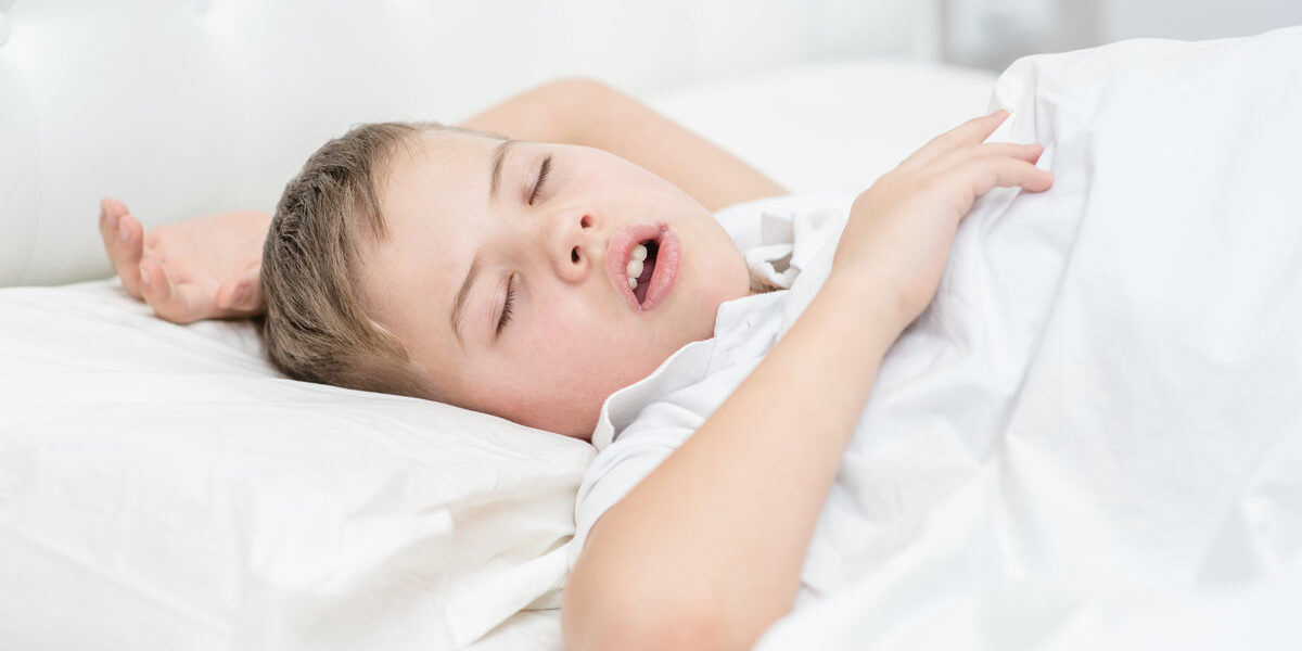 Little boy is sleeping with his mouth open, snoring Little boy is sleeping with his mouth open, snoring.
