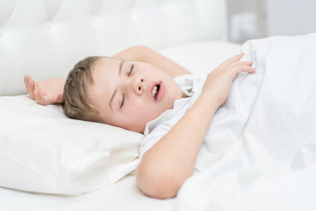 Little boy is sleeping with his mouth open, snoring Little boy is sleeping with his mouth open, snoring.